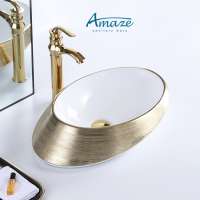 Hotel home decor chaozhou fancy luxury oval plated gold and white ceramic table top bathroom vessel sink art hand wash basin